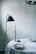 A minimalist dining table setting featuring crisp white plates and charcoal-toned serveware.