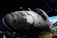 A space shuttle is prominently displayed, showcasing its black and white thermal tiles and windows. The backdrop includes a dimly lit room with a screen displaying an Earth view.