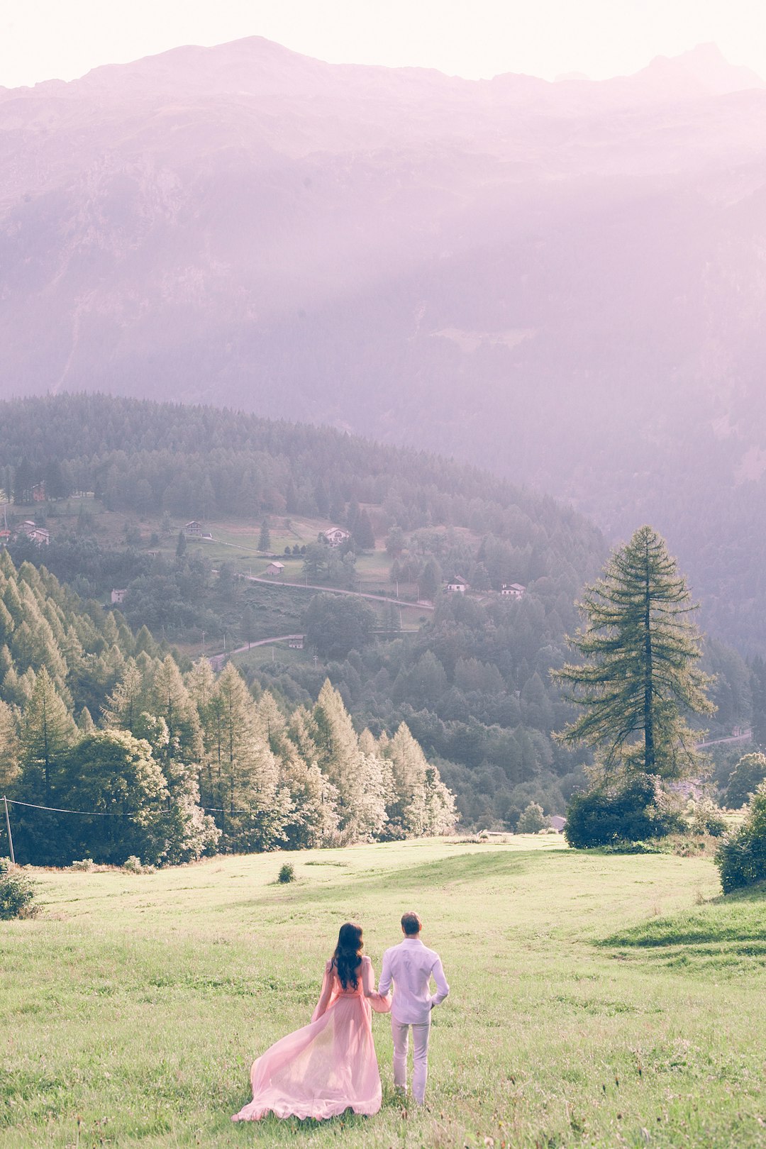 couple standing on grass field during daytime