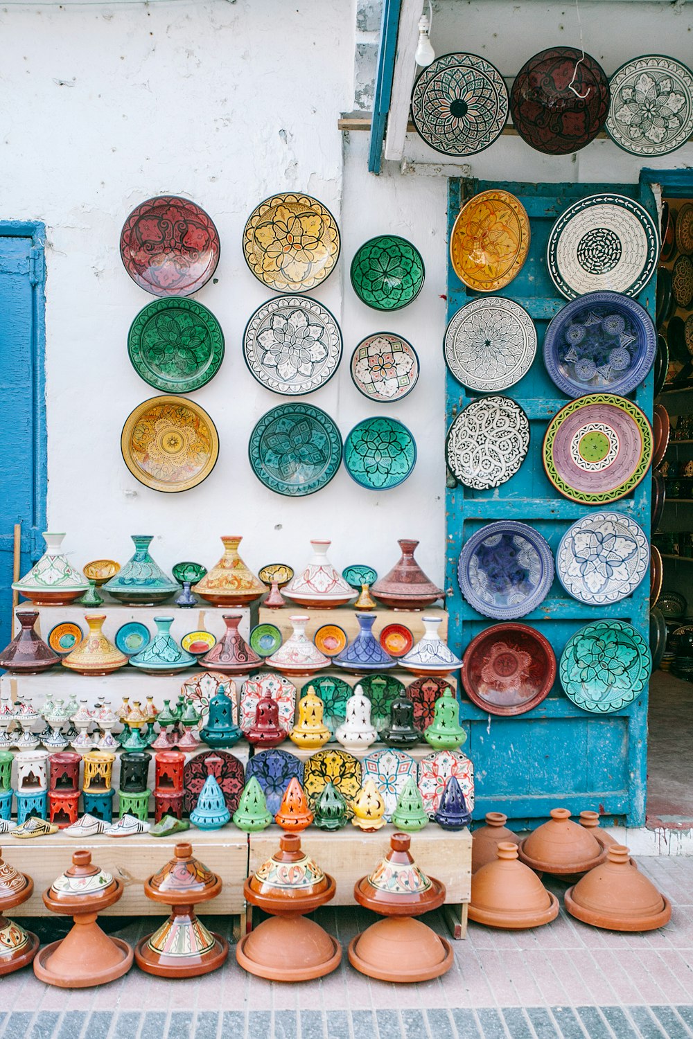 flower pots and decorative plates on wall