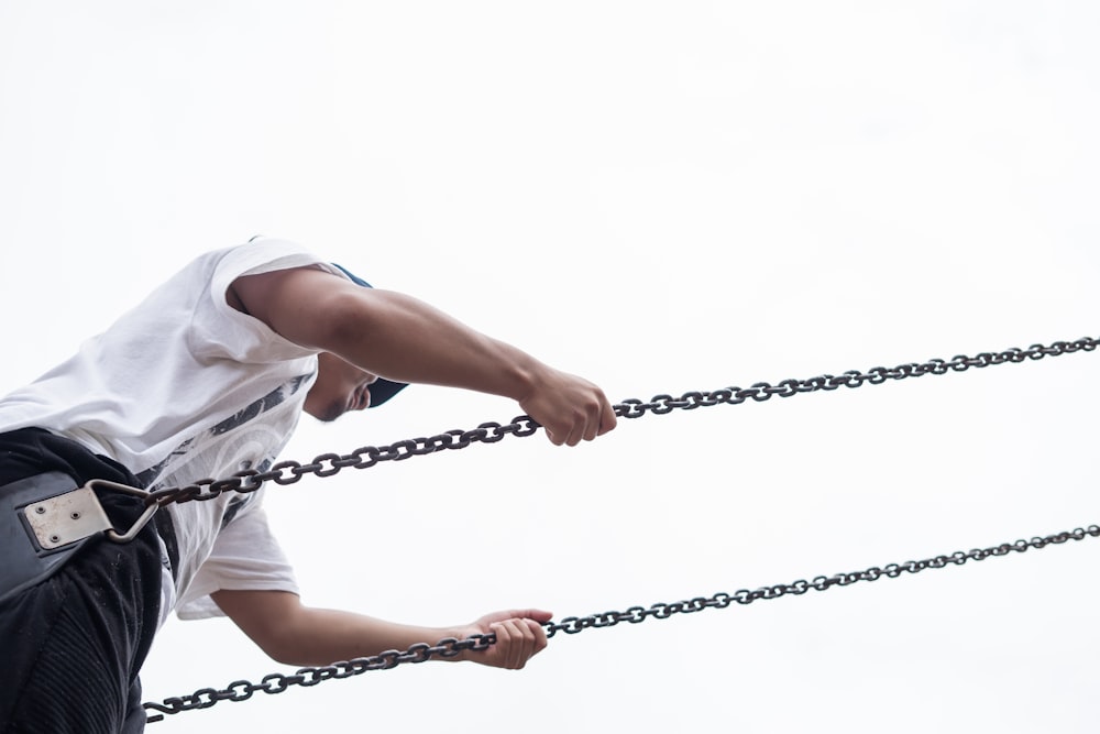 man sitting on swing chair