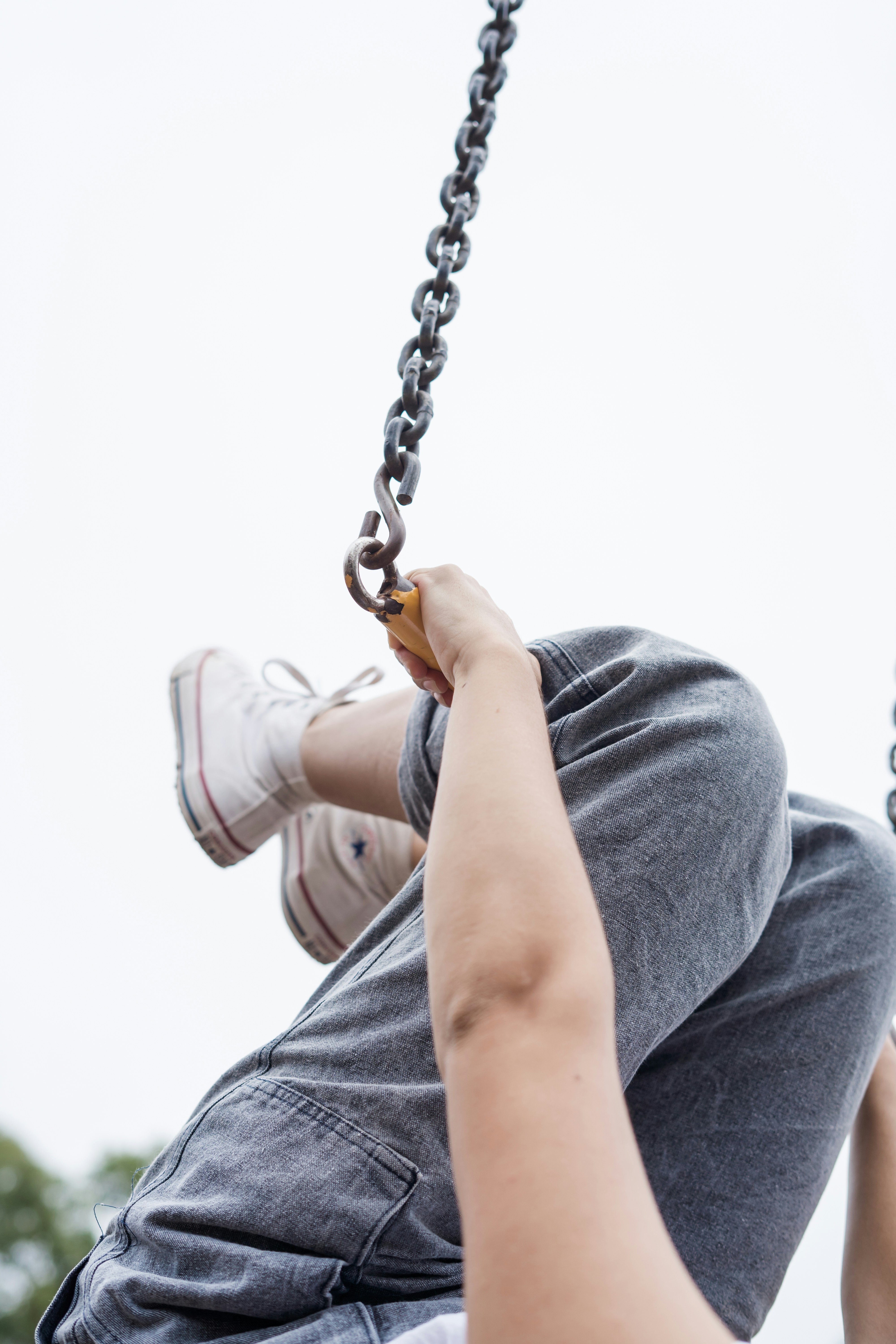person holding tight on metal chain