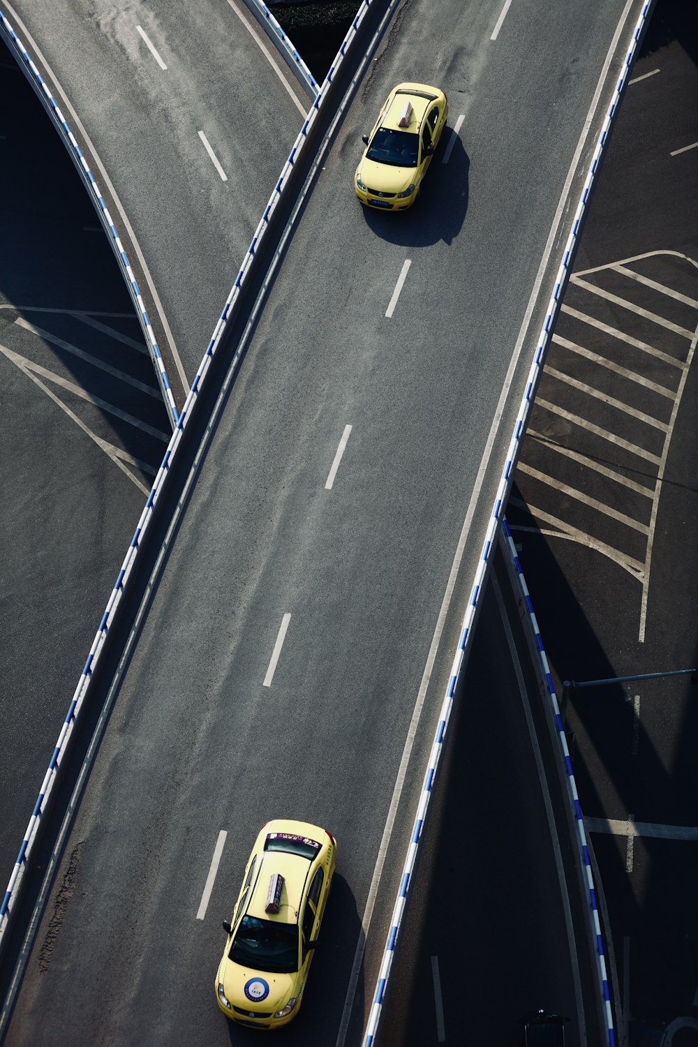two yellow cars on road during daytime