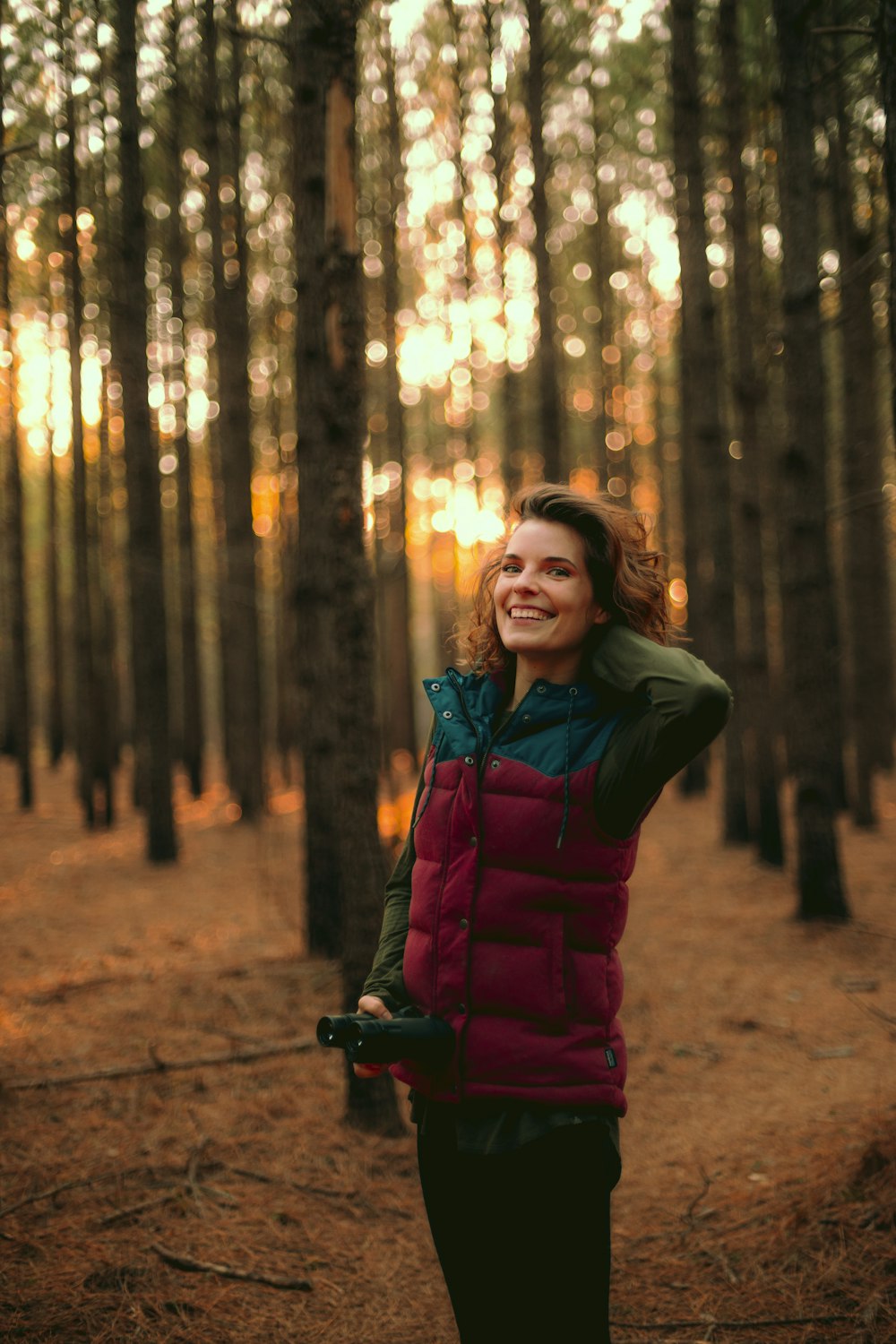 woman standing on forest during golden hour