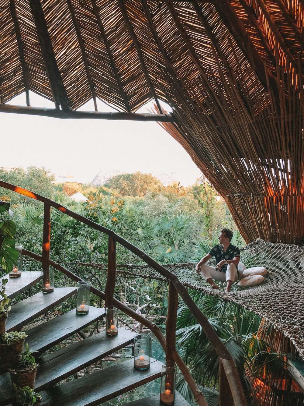 woman in white shirt sitting on brown wooden stairs