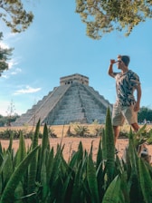 man standing in front of Chichen Itza, Mexico during daytime