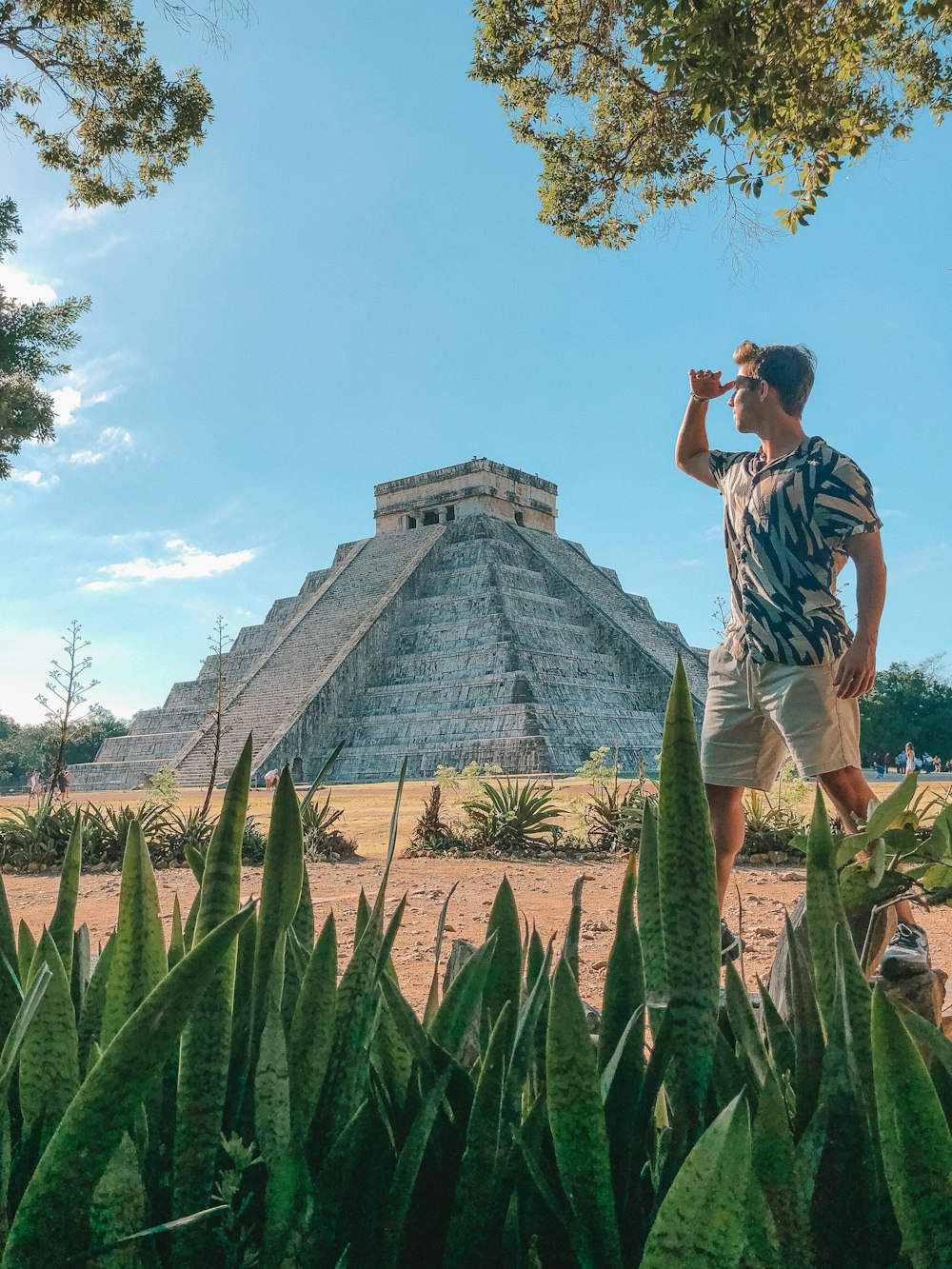 man standing in front of Chichen Itza, Mexico during daytime