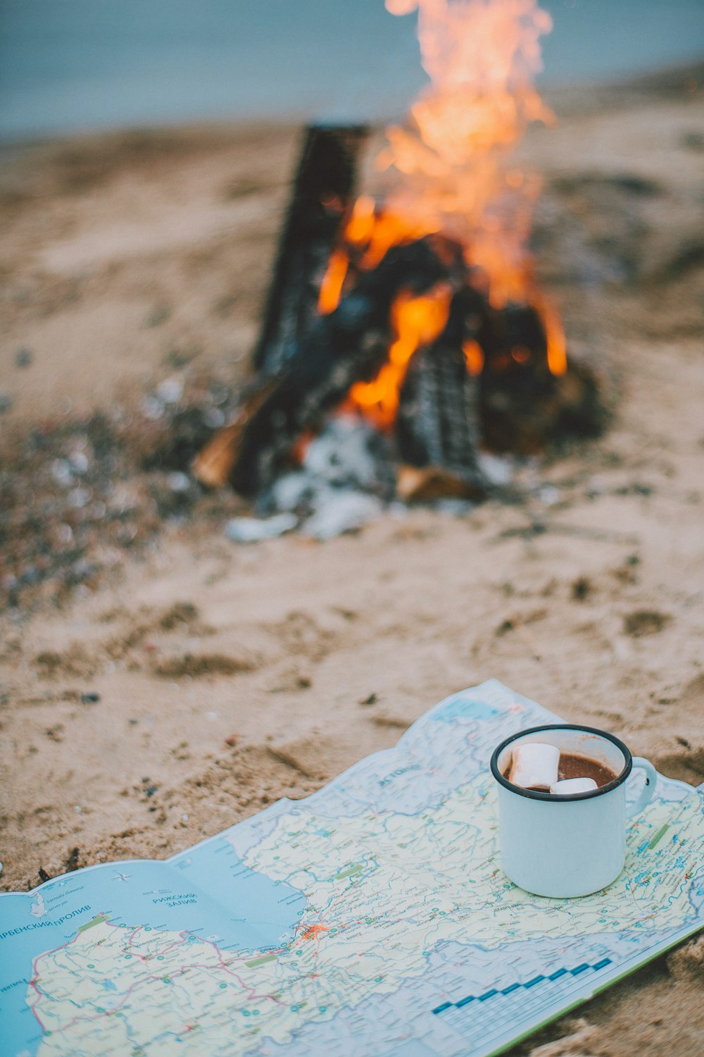 white cup near bonfire