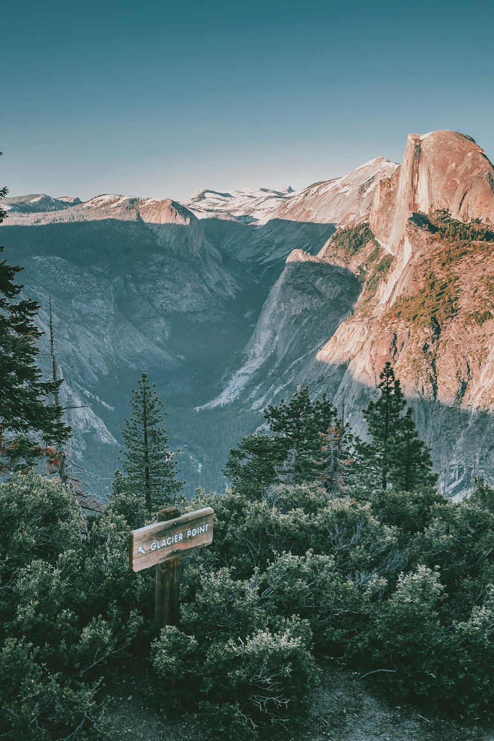 a view of a mountain with a sign in the foreground