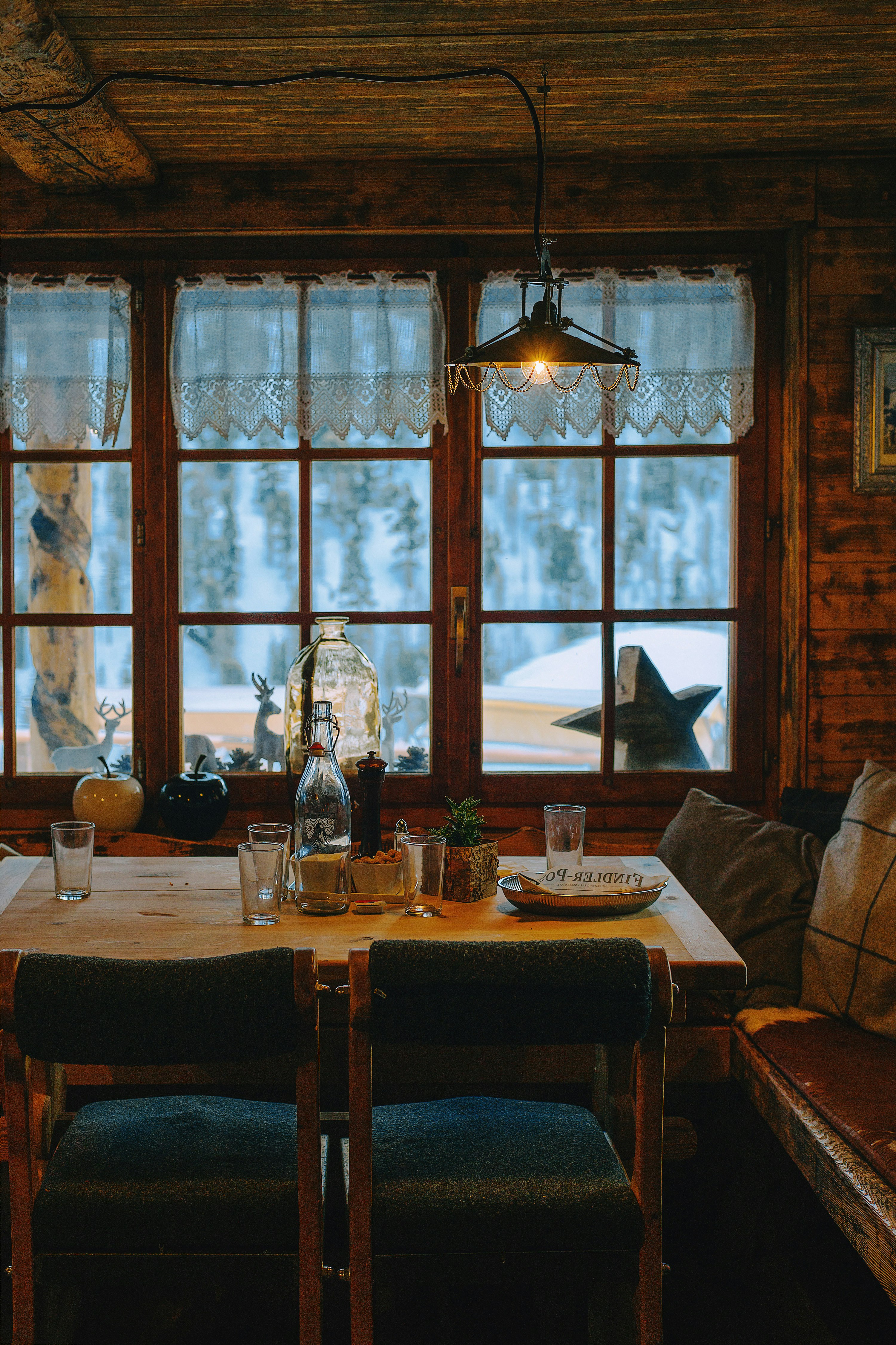 view of table with glasses near closed window