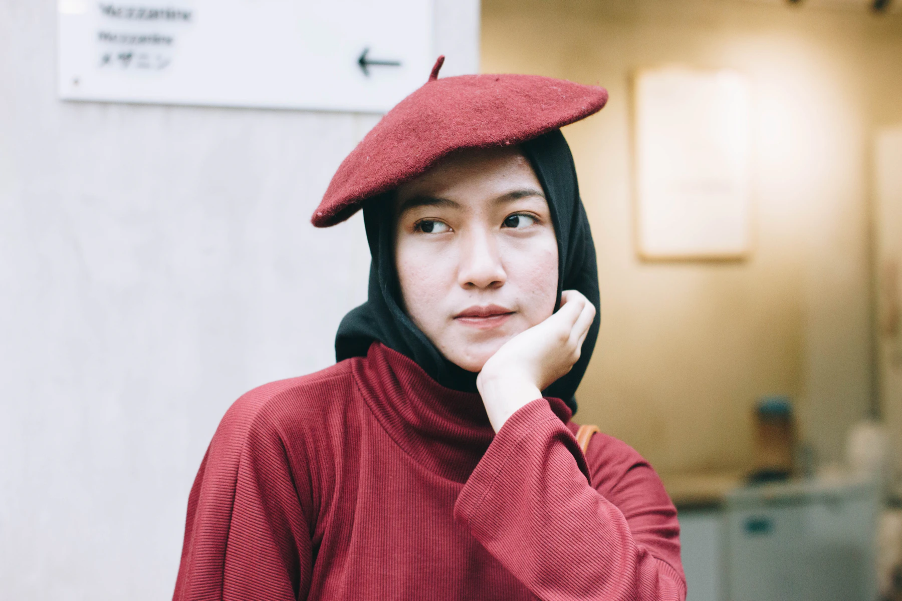 Woman gently resting her hand near her jawline
