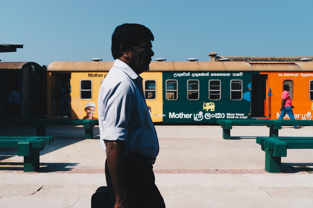 a man walking in front of a train station