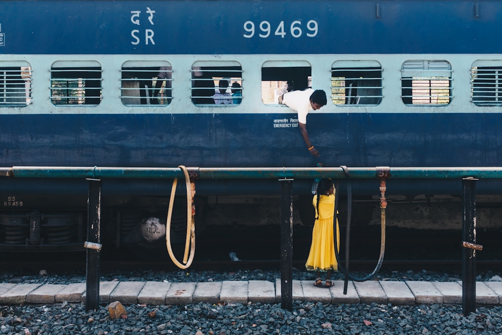 man in white top in train