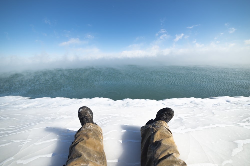 man resting legs on ice