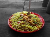 An inviting plate filled with colorful Thai food including noodles and vegetables.