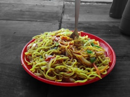 An inviting plate filled with colorful Thai food including noodles and vegetables.