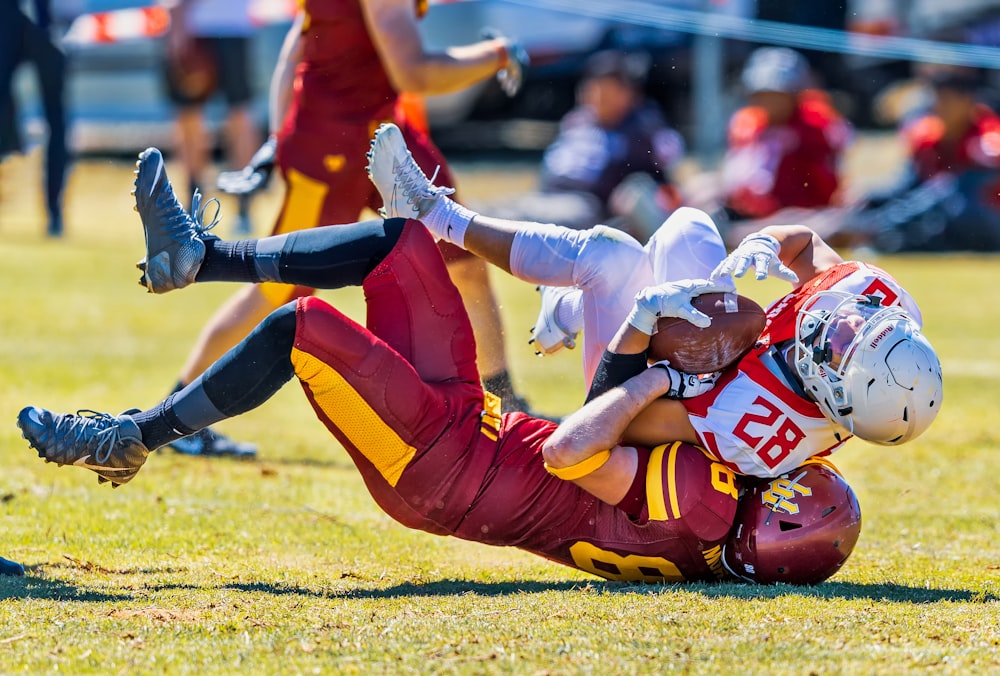 selective focus photography of two football players fighting of the ball during daytime