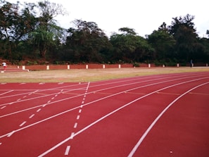 Athletes training on a well-maintained running track.
