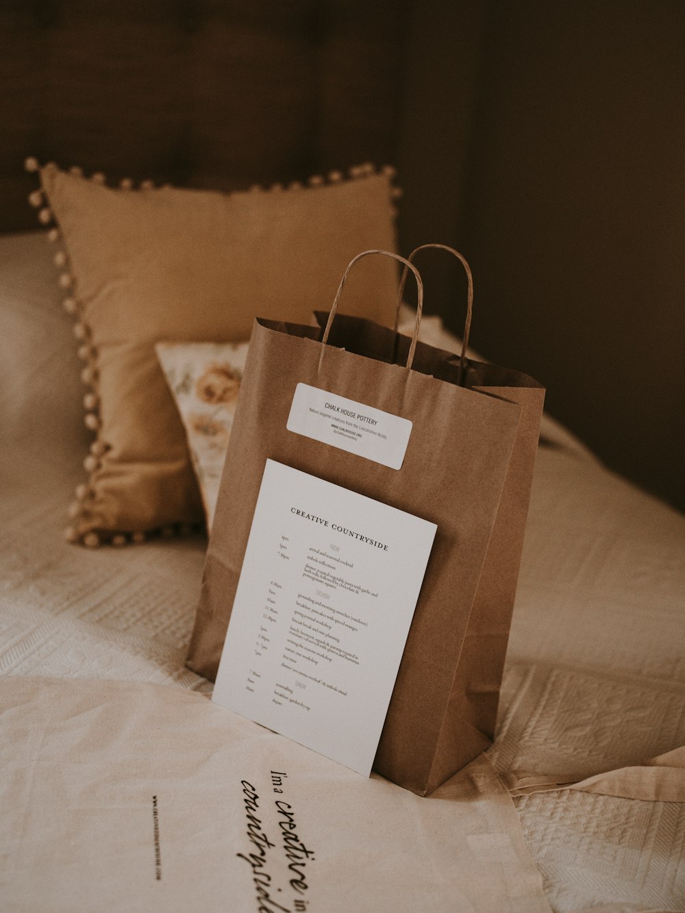 brown paper bag beside pillow