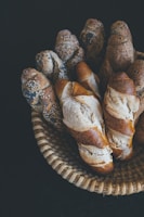 Artisan baguettes with a crispy crust displayed in a rustic basket.
