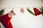 A series of fabric bags and stockings are hanging from a line. The items have numbers on them, including 17 and 20, and feature a Christmas theme with a mix of red, green, and white colors. The stockings and bags appear to be part of an advent calendar.