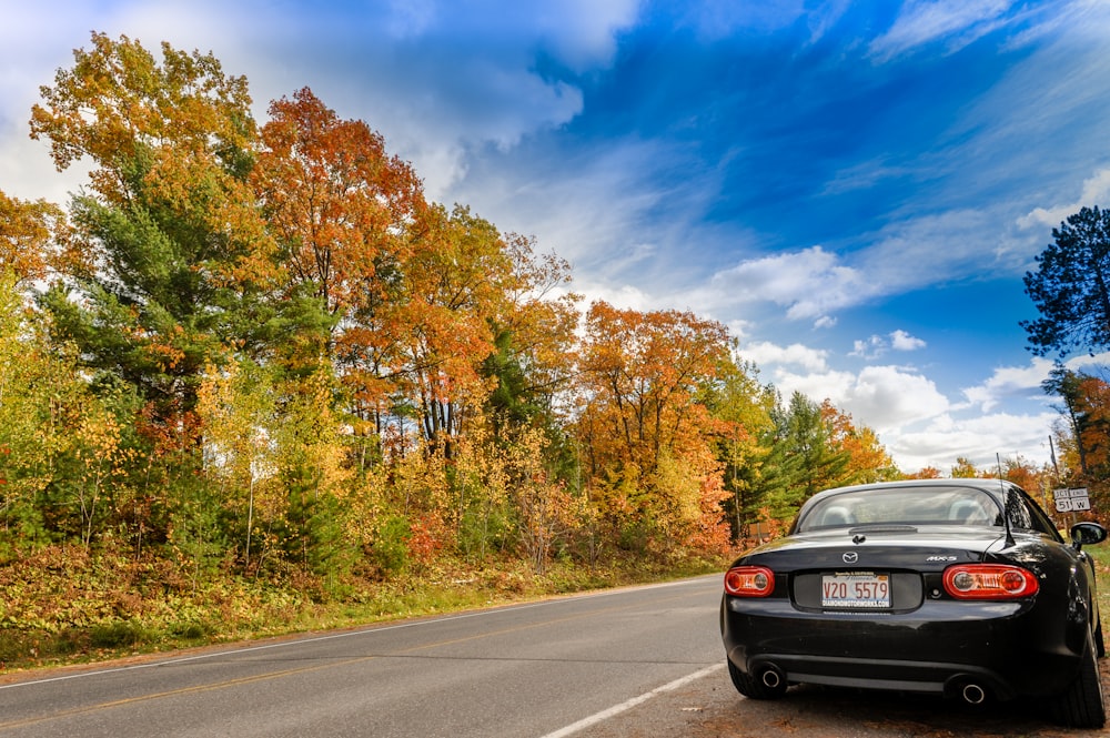 black coupe parked on road side