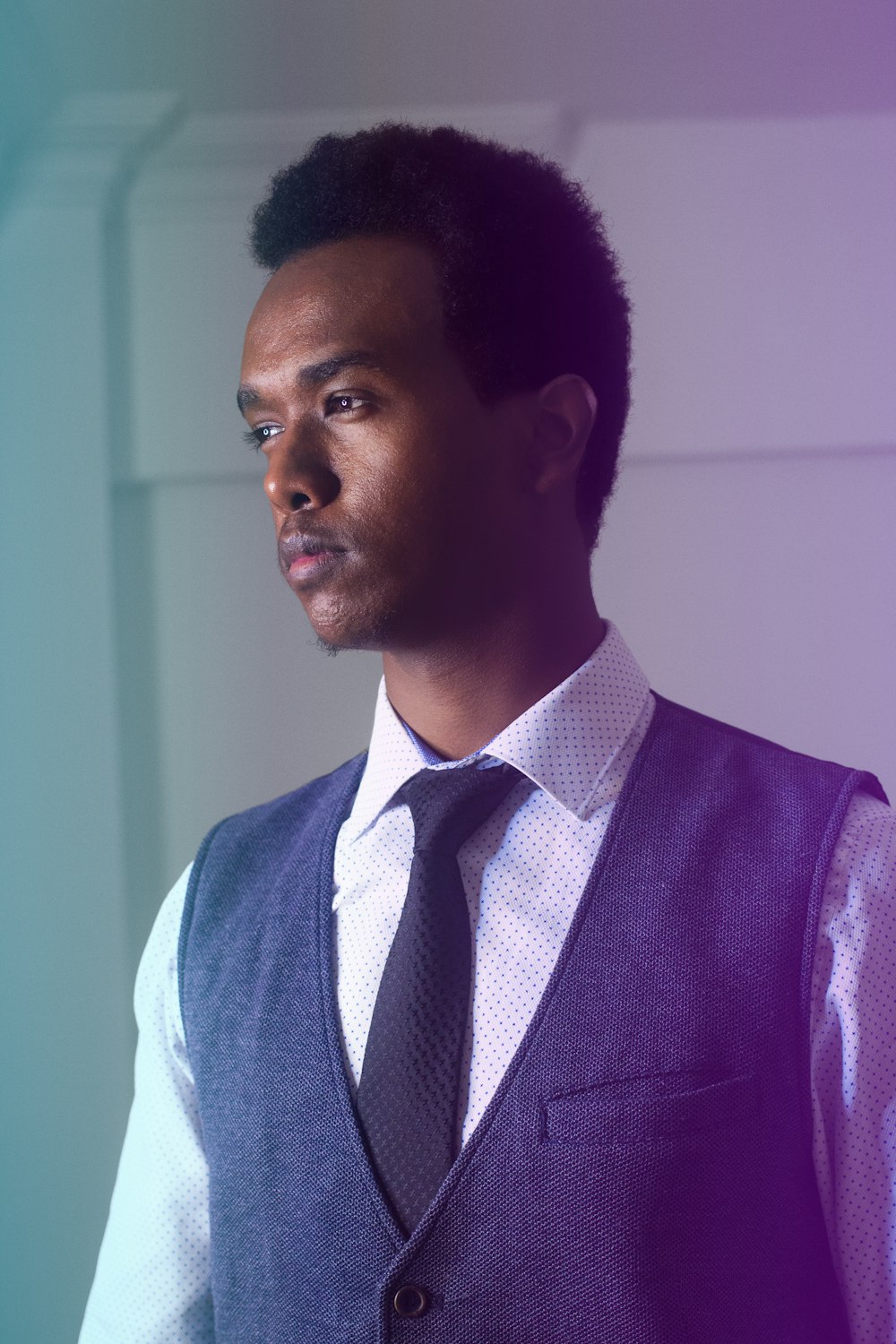 man wearing white dress shirt and black vest