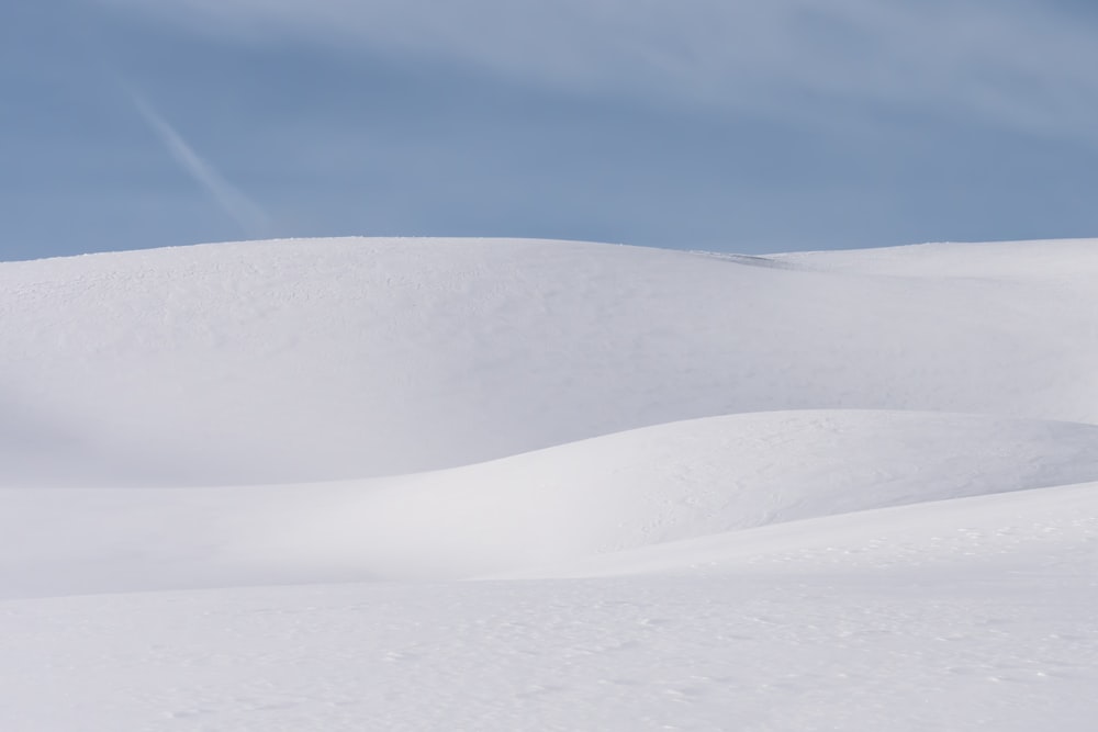 a man riding skis down a snow covered slope