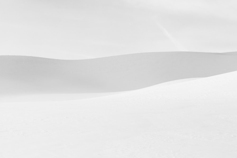 a man riding skis down a snow covered slope