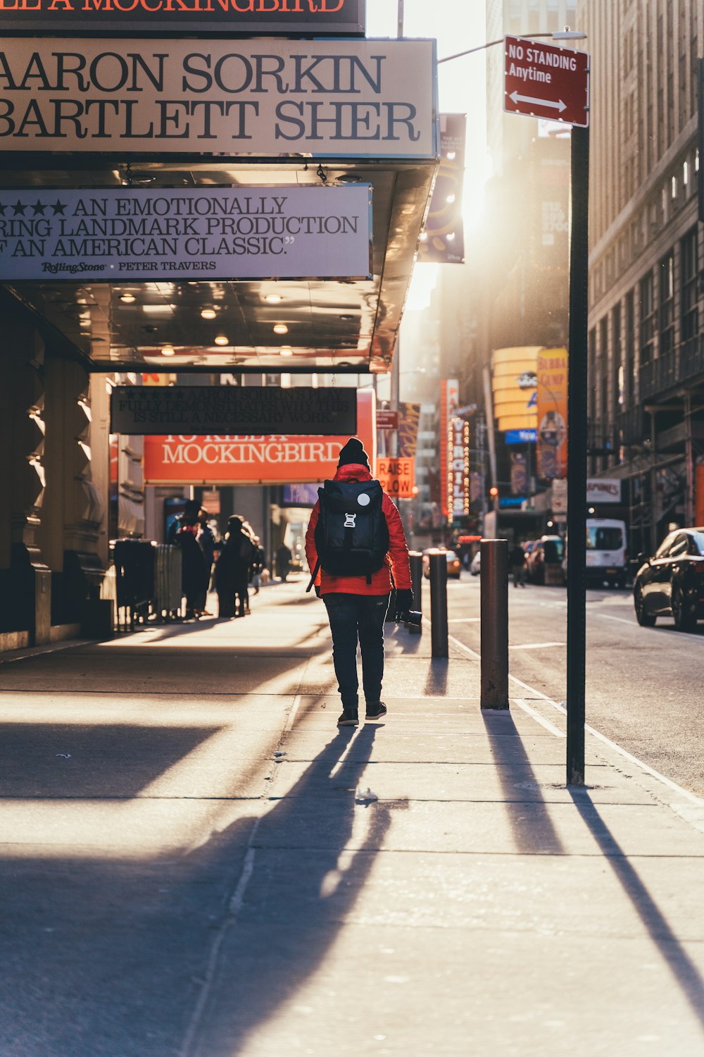person walking on sidewalk during golden hour