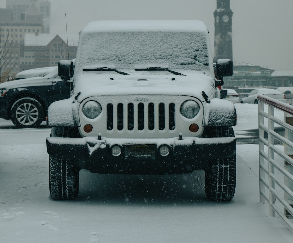 white Jeep Wrangler covered by snow