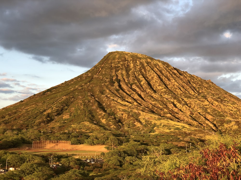 brown mountain under white skies