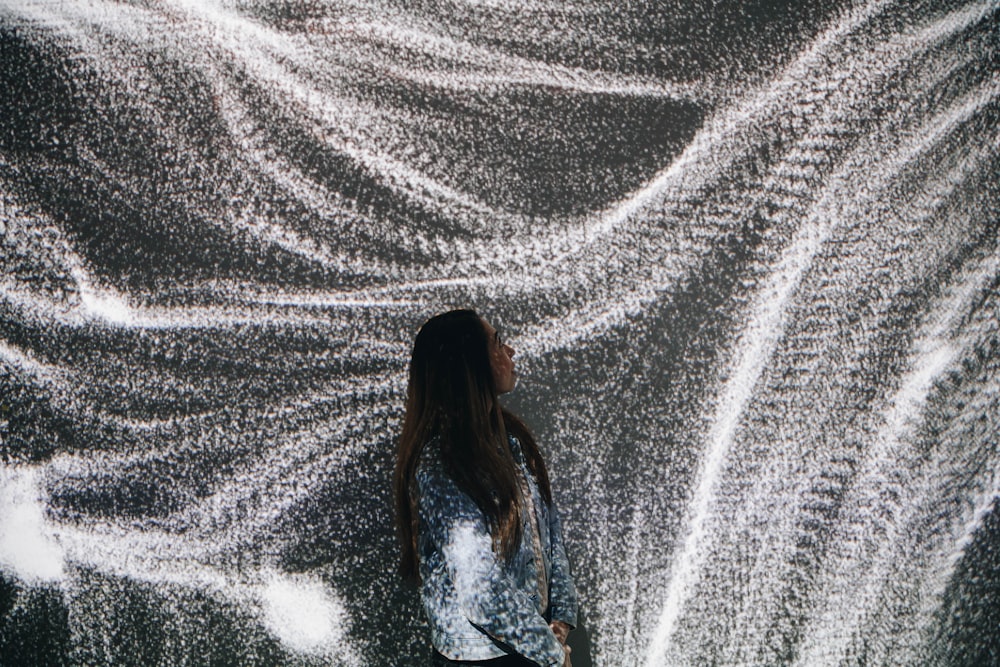 woman standing beside white surface