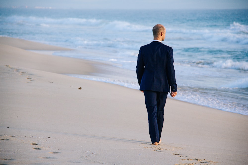 man walking on shore during daytime