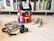 A stylish Loungefly backpack resting on a wooden shelf with collectibles around.