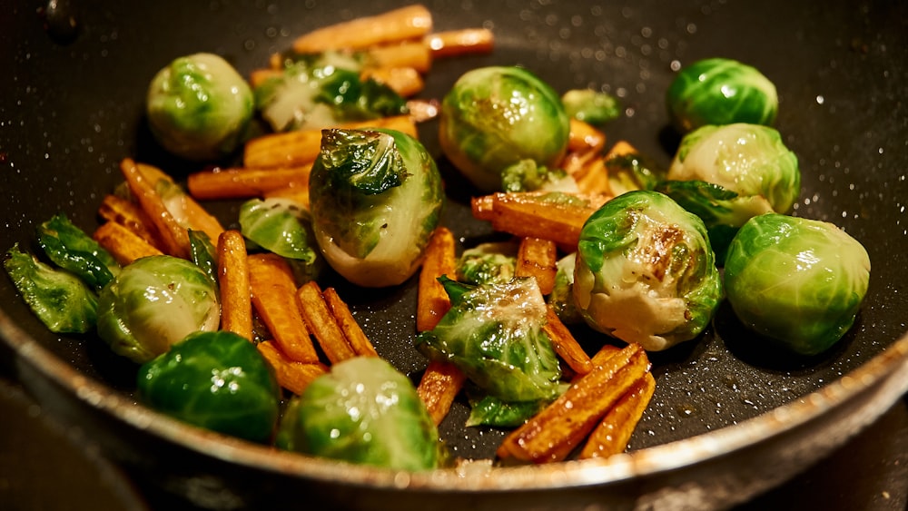 carrots and green vegetable on stainless steel strainer