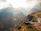 person paragliding on mountain cliff during daytime