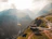 person paragliding on mountain cliff during daytime