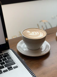 An elegant cup of coffee with latte art, surrounded by subtle digital interface elements.