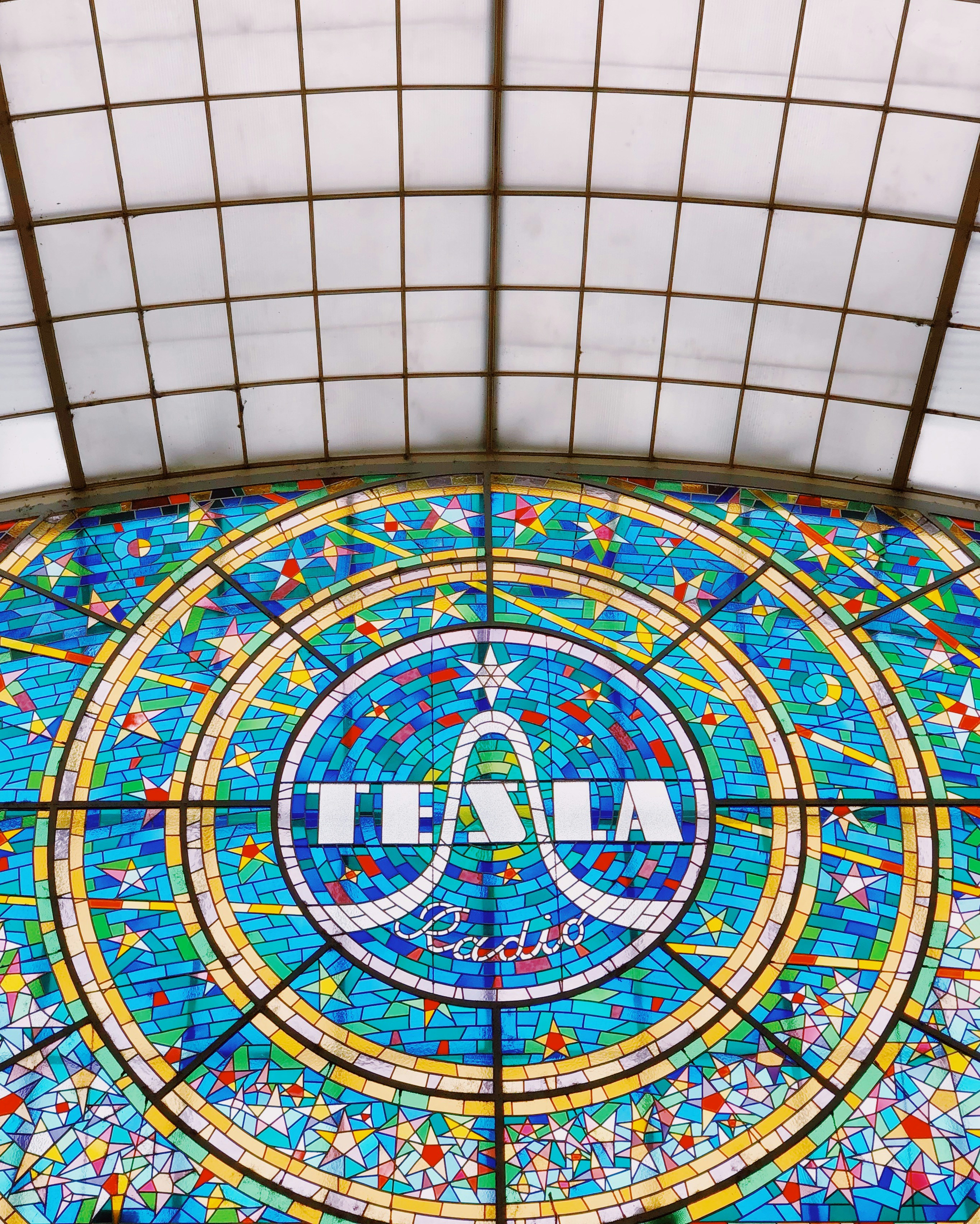 blue and yellow Tesla stained glass window
