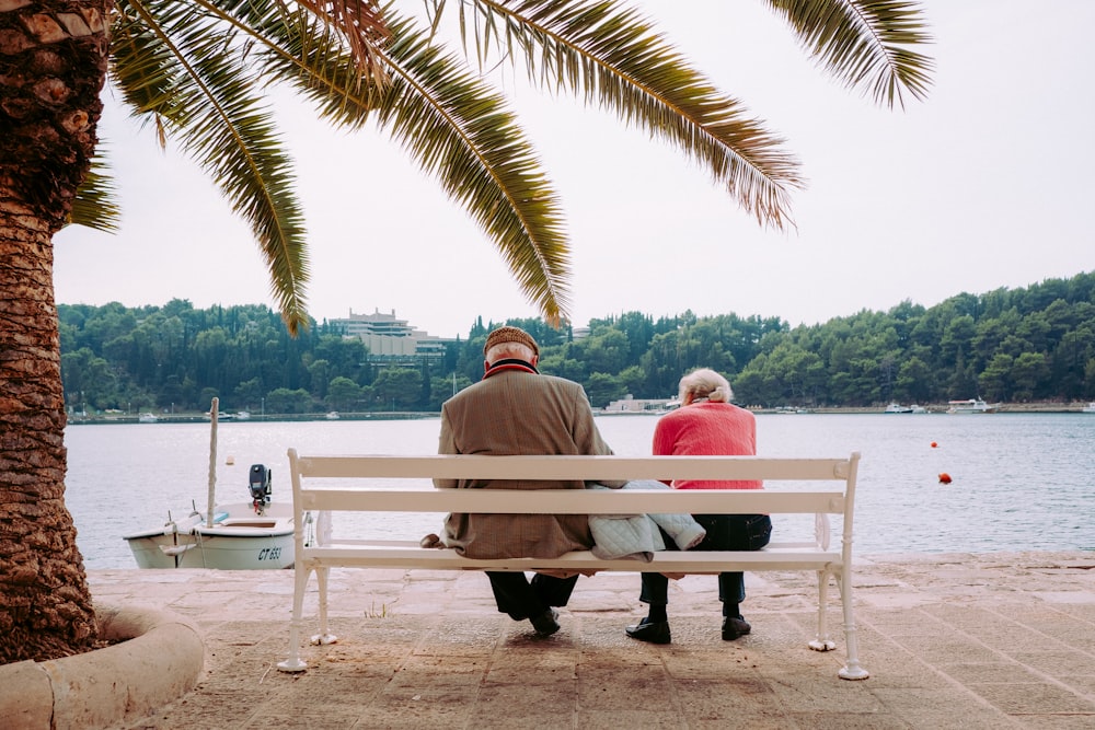 coupe sitting on white bench near body of water