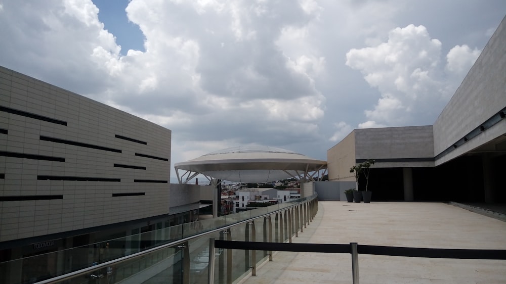 concrete buildings under white clouds at daytime