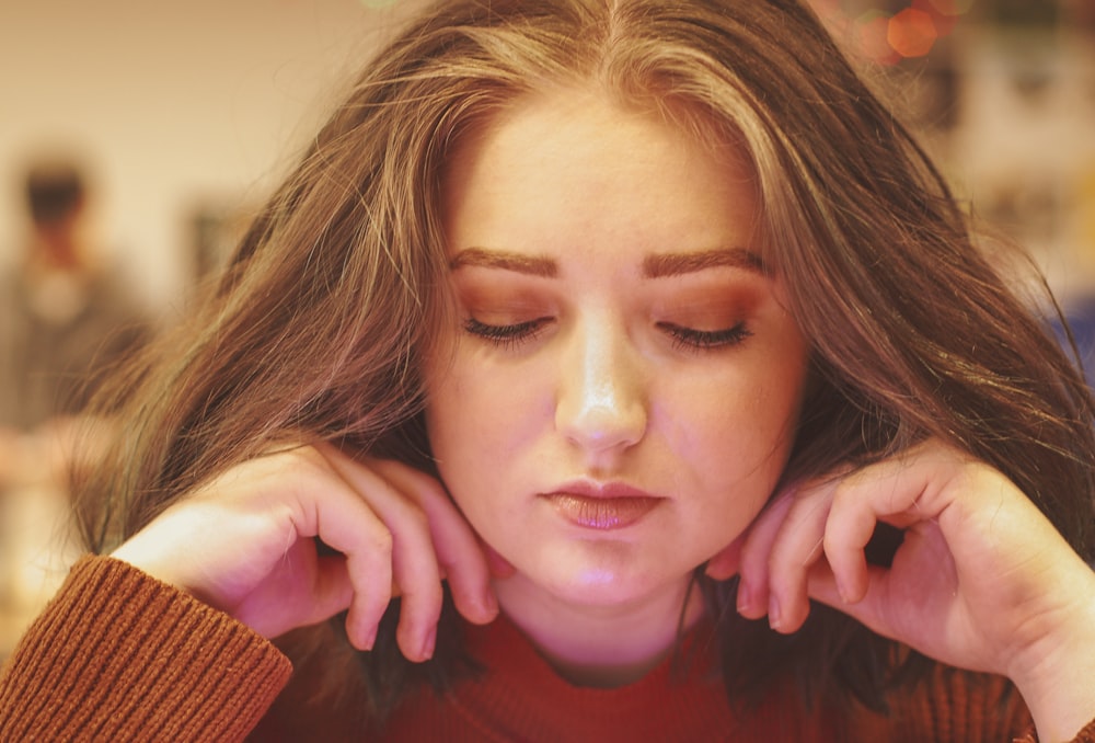 woman in maroon sweater on focus photography