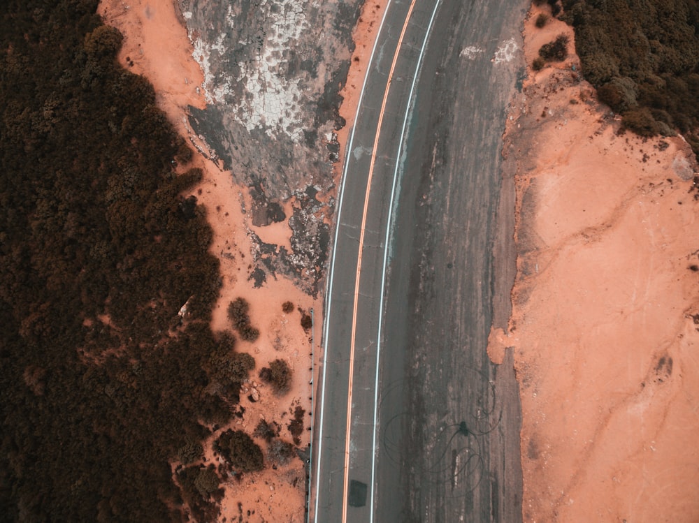 aerial view of road surrounded with mountains