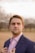 man wearing inner dress shirt with black blazer standing outside at daytime