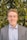 man in grey blazer near green trees during daytime