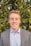 man in grey blazer near green trees during daytime