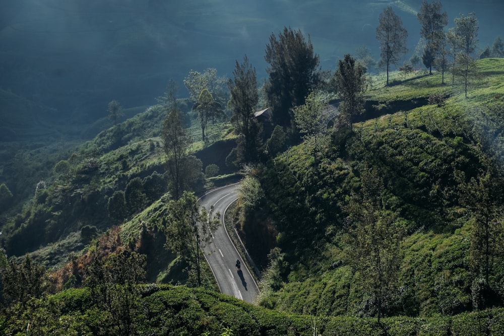 aerial view of road surrounded with mountains