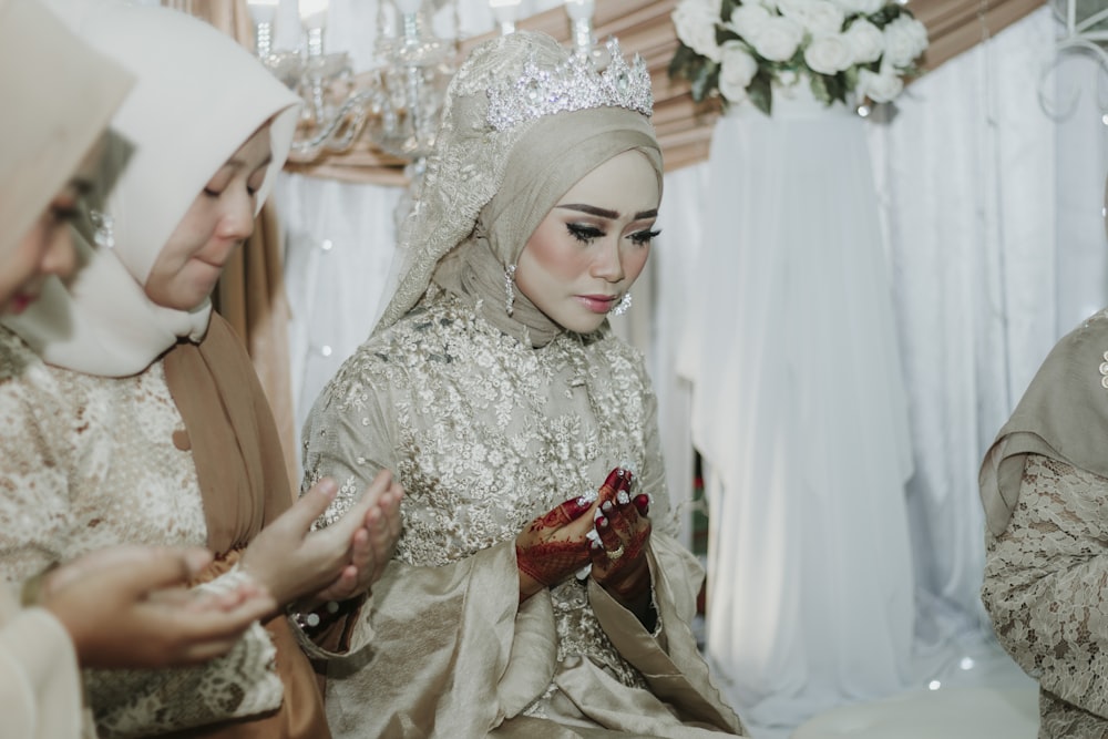 bride wearing beige abaya dress and tiara