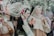 A group of diverse people enjoying a cultural event outdoors, with colorful decorations and traditional attire.